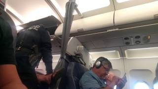 5 police officers escorting resisting lady off plane crazyy [upl. by Ellecrag]