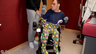 Strampler im Rollstuhl anziehen Guy with infantile cerebral palsy puts on romper suit  wheelchair [upl. by Irt]