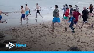 Hundreds of Scots brave the cold for Loony Dook dips [upl. by Scharaga]