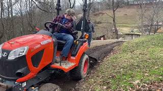 Kubota BX2380 cleaning a ditch and sloping a driveway [upl. by Nuriel536]