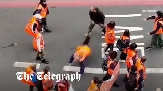 Just Stop Oil protester thrown to ground by enraged motorist [upl. by Eigla218]