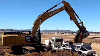 CAT 349E excavator loading belly dump trucks with four passes [upl. by Leahicm]