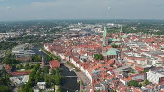 Aerial shot of old town centre View of Holstentor Marienkirche and several other churches Luebeck [upl. by Llibyc]