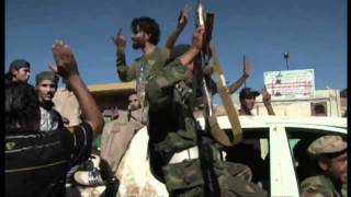 Libyan rebels fly flag in Zawiyah [upl. by Combes]