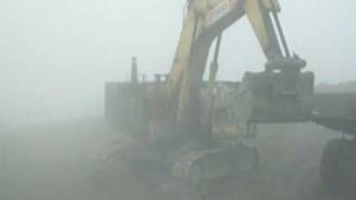 Komatsu PC1250 loading CAT 775 DE in fog [upl. by Boff]