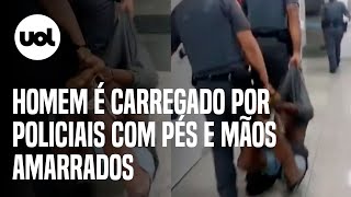 Homem negro é carregado com pés e mãos amarrados por PMs após prisão em SP veja vídeo [upl. by Aketal550]