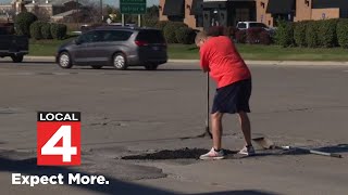 Michigander takes action to fix the ‘damn’ roads himself [upl. by Selestina260]