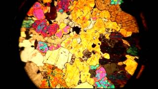 A thin section viewed through a petrographic microscope with stage rotation [upl. by Tnelc633]