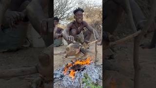 Hadzabe cooking the Whole guinefowl on the fire  primitive cooking [upl. by Ellynad]