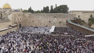 Jewish worshippers gather at Jerusalems Wailing Wall for the traditional priestly blessing prayer [upl. by Aihsel925]