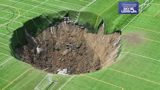 Surveillance video shows moment when 100footwide sinkhole swallows Alton Illinois soccer field [upl. by Emogene]