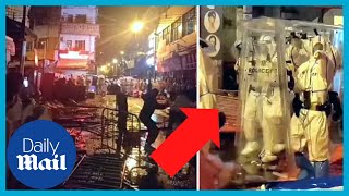 China Antilockdown protesters throw glass bottles at riot police in Guangzhou [upl. by Aerdnaid]