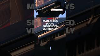 Man plays piano suspended vertically [upl. by Fitzhugh]