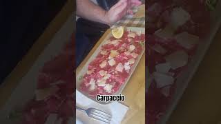 carpaccio is a dish served raw with oliveoil lemon parmigianoreggiano olioextravergine limone [upl. by Eintihw]