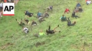 WATCH Englands annual cheese rolling race [upl. by Etnuhs806]