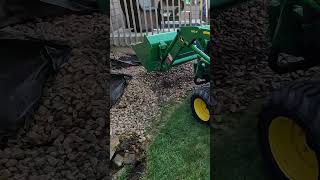 John Deere 1025r Removing Landscape Rock Fast [upl. by Dickson]