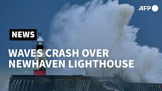 Waves crash over Newhaven Lighthouse as Storm Bella batters Britain  AFP [upl. by Sacram454]