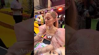 Ariana Grande DRAWS tattoos for fans at wicked premiere [upl. by Reifinnej]