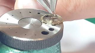 Attaching a watch hairspring onto balance wheel [upl. by Yemerej]