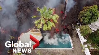 La Palma volcano Drone video shows black lava swallowing pool homes on its way to coast [upl. by Archambault596]