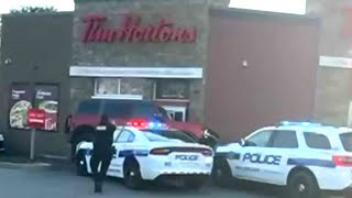 Wild getaway attempt at Tim Hortons drivethru  Suspect drives over police cruiser [upl. by Lleuqram]