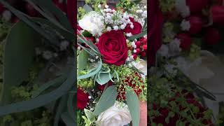 A stunning cascade wedding bouquet of red and white roses and trailing foliage weddingbouquet [upl. by Znarf538]