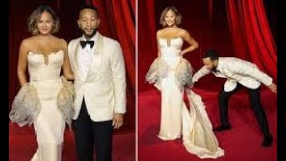 Doting husband John Legend fixes wife Chrissy Teigens dress on the red carpet as the pair attend [upl. by Howey]