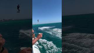 Wind Kite Surfer Grabs Drink from Boat Before Flying Through the Air Over Palm Beach Aruba shorts [upl. by Einyaj208]