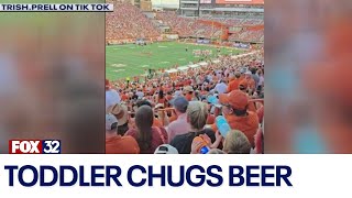 Across America Toddler spotted chugging beer at college football game [upl. by Suirtemid]