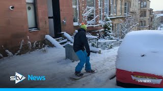 Snowboarder spotted gliding down Glasgow street [upl. by Abran]