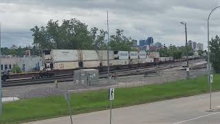 Eastbound CN intermodel cruises past Fort Rouge yards while BNSF 1545 switches the yard 61824 [upl. by Adelric249]