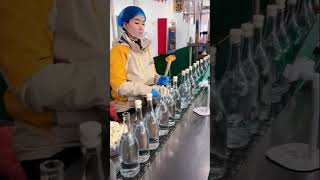 The process of closing bottles with corks on a conveyor belt [upl. by Lovash]