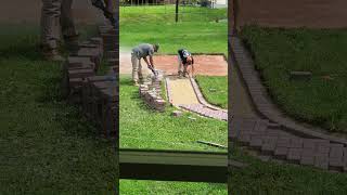 Brick masons finishing up garden pathway [upl. by Gan874]