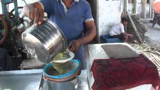 Sugar Cane Juice vendor on Chalthan Village Road Chalthan Gujarat India 18th May 2012 [upl. by Ysdnil891]