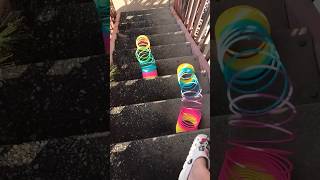 Giant slinky rolling down the stairs satisfying slinky slinkytricks shorts [upl. by Palladin]