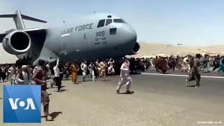 Afghans Try to Flee at Kabul Airport [upl. by Eniamirt]