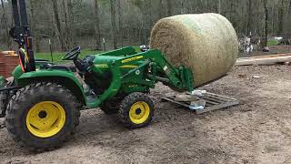 John Deere 3032E handling a round bale of hay [upl. by Nerraw]