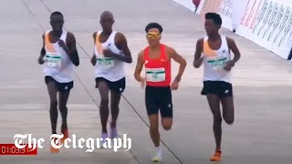 Runners appear to let Chinese contestant win Beijing halfmarathon [upl. by Rednirah]