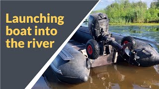 Boat launching into the river using transom launching wheels [upl. by Ennalorac]