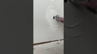 Skim coating a broken outlet drywall repairs construction fyp [upl. by Salokcin]