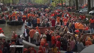 Dutch capital turns orange as revelers celebrate Kings Day with colorful canal parade [upl. by Ogawa]