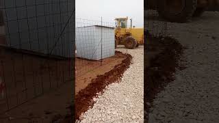 Coating of a construction site road muddy from the rains with a layer of gravel [upl. by Adiel]