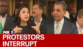 NYC migrant crisis AOC interrupted by protesters at Roosevelt Hotel [upl. by Amathiste]