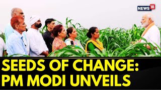 PM Modi Unveils 109 Highyielding Climateresilient Crop Varieties Interacts With Farmers  Nws18 [upl. by Bibbye]