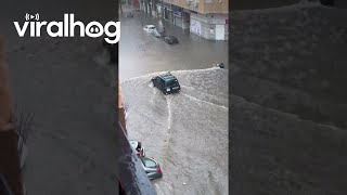 Car Drives Through Flooded Street in Spain  ViralHog [upl. by Audette]