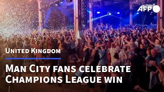 Fans in Manchester go wild as Man City win Champions League  AFP [upl. by Skoorb]