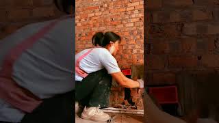 Beginning the process of installing plastic plumbing pipes in a brick wall [upl. by Leblanc]