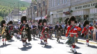 Drum Majors lead the combined Pipe Bands over river Dee marching to 2022 Ballater Highland Games [upl. by Llenaej]