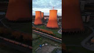 Train travels past RatcliffeonSoar power station cooling towers at sunset Drone Video [upl. by Geneva]