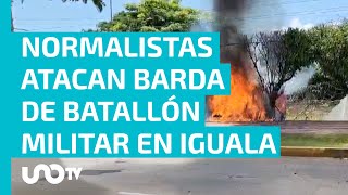 Normalistas de Ayotzinapa lanzan petardos y estrellan vehículo contra barda de la zona militar [upl. by Freddie]